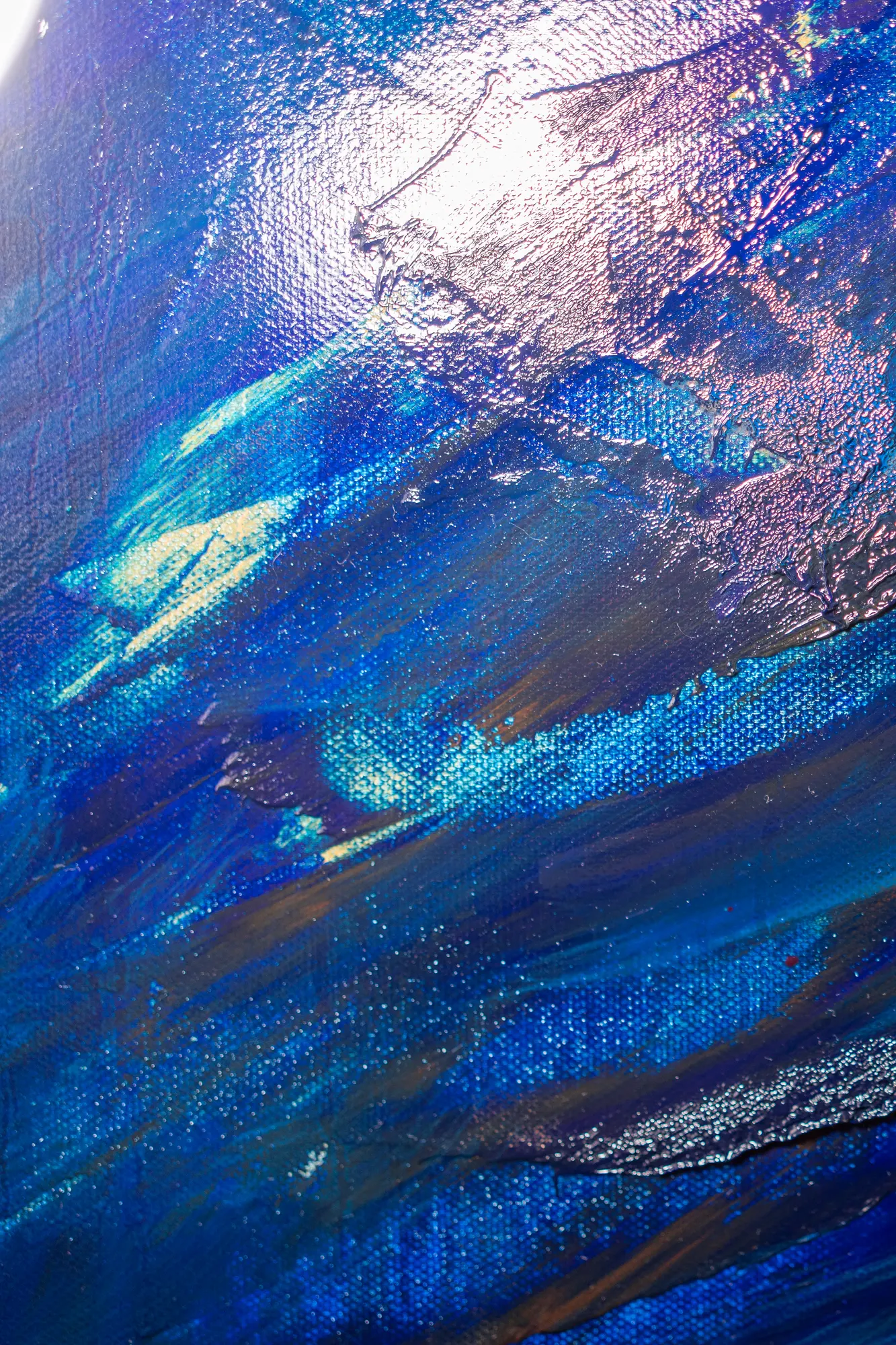 A tall slice of the calm upper left, smooth blue strokes over open canvas weave.