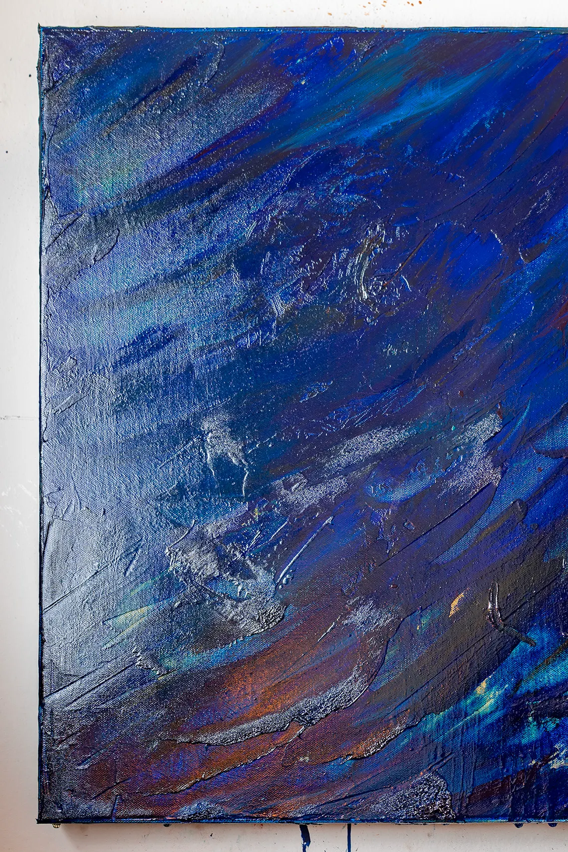 A tall slice of Blue #1 taken at its left edge, where the canvas meets the studio wall.