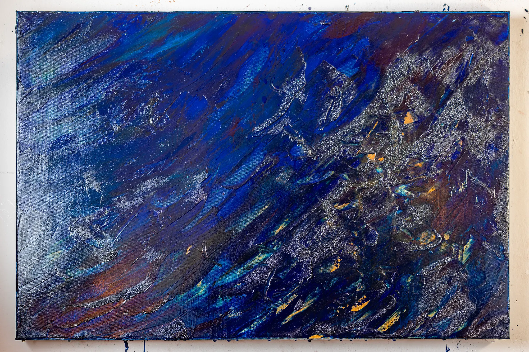 The same canvas seen from further back, the wall around it visible.