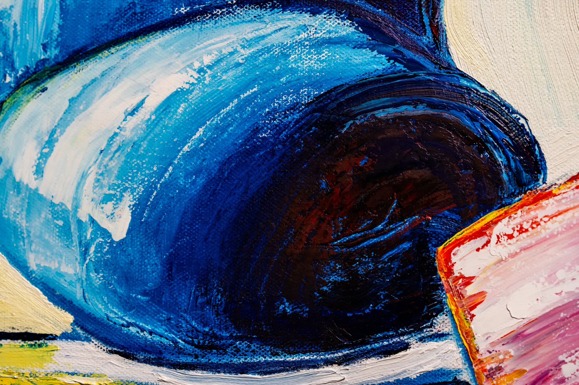 Close view of the blue vessel, its curved rim sweeping around a dark brown interior.