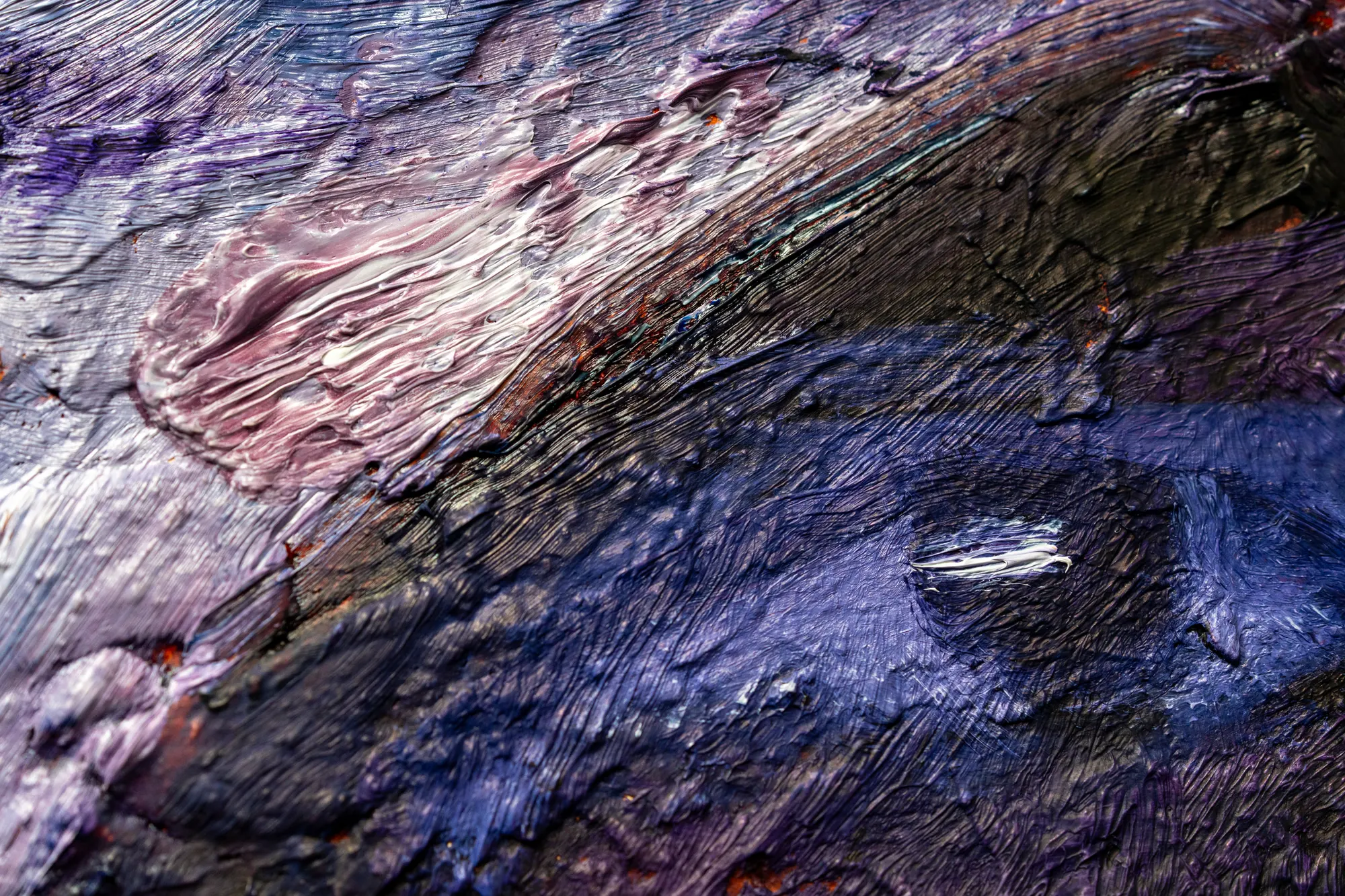 Close view of lavender and white strokes laid in ridges beside deeper violet.