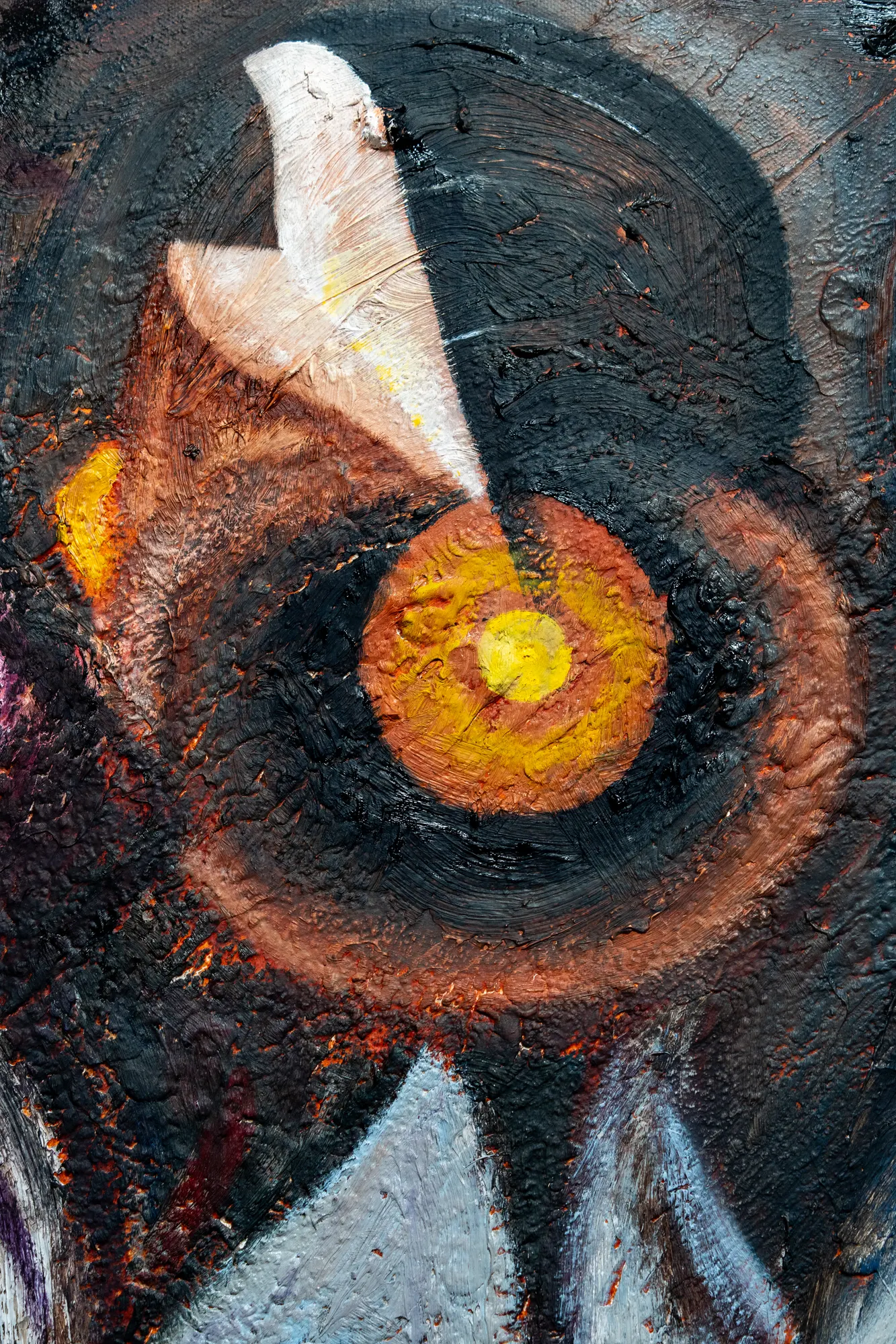 Upright close view of the orange concentric eye with a yellow centre, a pale wing shape cutting across it.