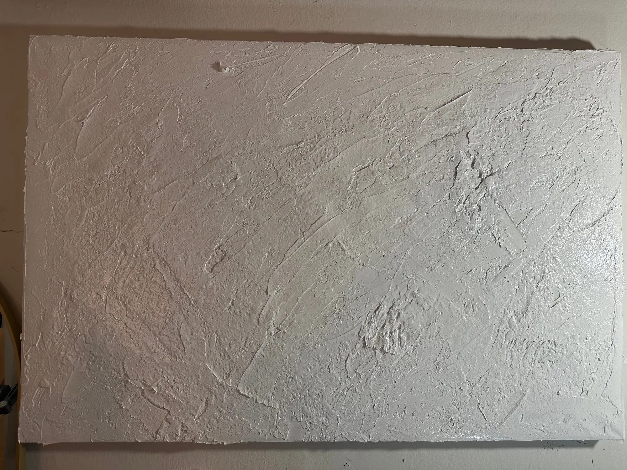 The finished ground on canvas, still wet, worked into broad ridges and knife sweeps with a torn irregular edge.